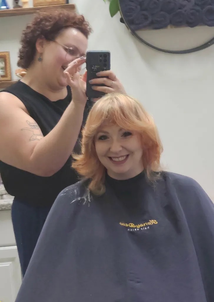 Stylist coloring a client's hair in the salon